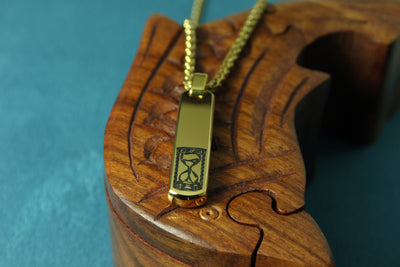 Gold necklace with a pendant on a wooden surface
