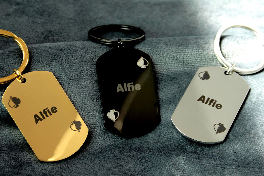 Three keychains with 'Alfie' engraved on them, each on a different background.