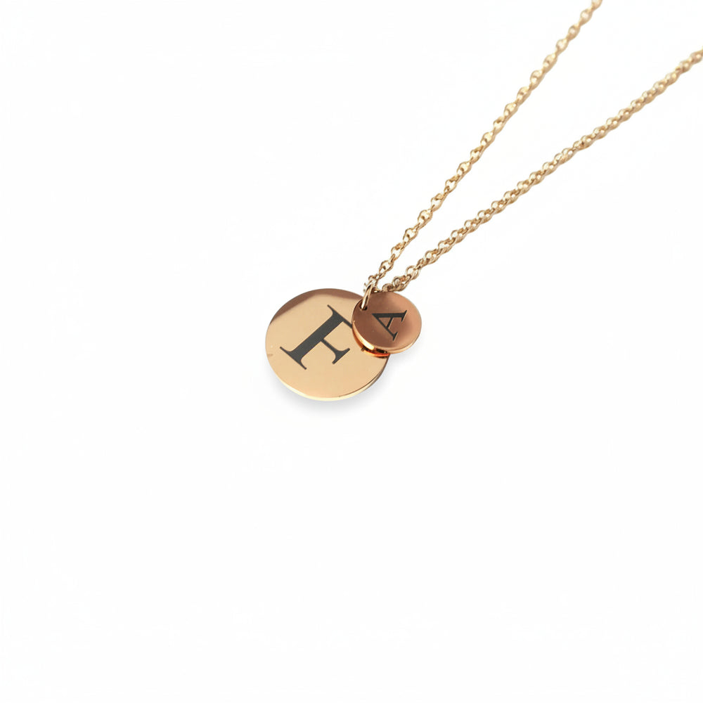 Gold necklace with round pendants on a white background